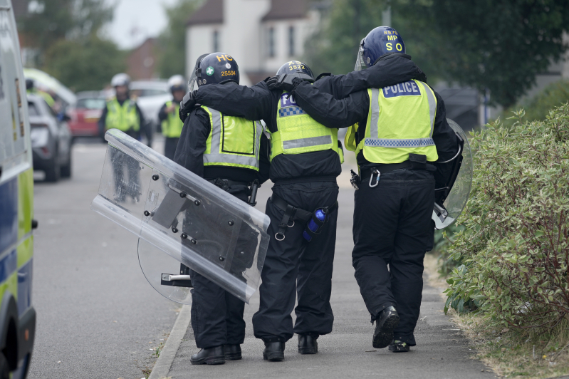 Riot police are seen outside of the Holiday Inn Express in Manvers, UK