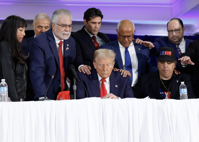 People pray with Republican presidential nominee, former U.S. President Donald Trump